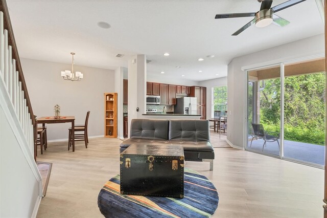8228 Villa Grande Ct, Sarasota, FL 34243 - living area featuring stairs, baseboards, light wood-style floors, recessed lighting, and a ceiling fan