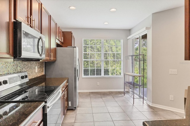 8228 Villa Grande Ct, Sarasota, FL 34243 - kitchen with appliances with stainless steel finishes, decorative backsplash, light tile patterned floors, recessed lighting, and baseboards