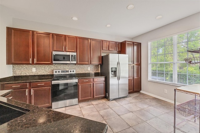 8228 Villa Grande Ct, Sarasota, FL 34243 - kitchen featuring stainless steel appliances, backsplash, dark stone counters, baseboards, and recessed lighting