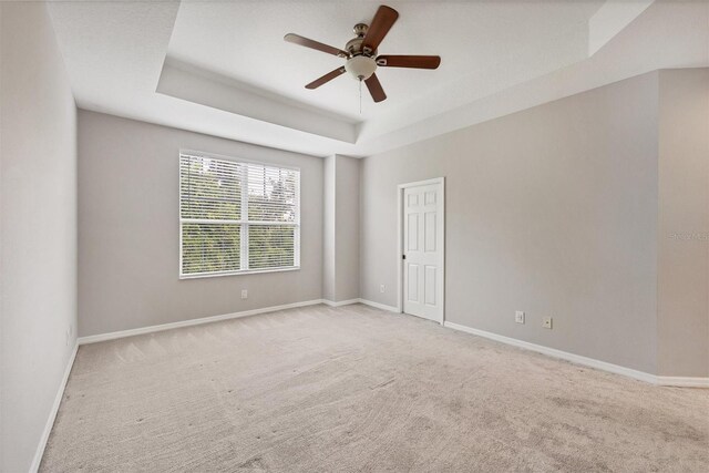 8228 Villa Grande Ct, Sarasota, FL 34243 - carpeted empty room with a raised ceiling, baseboards, and ceiling fan