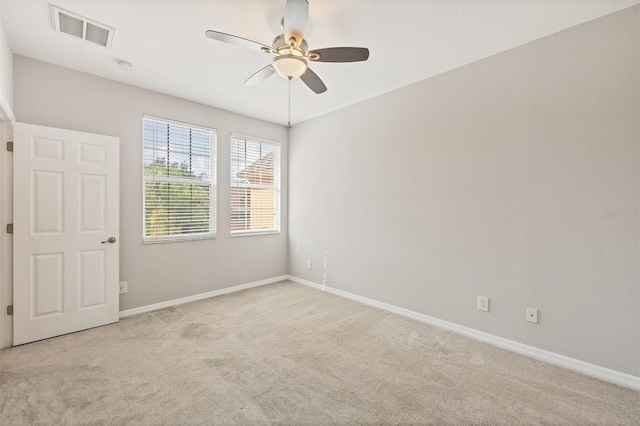 8228 Villa Grande Ct, Sarasota, FL 34243 - empty room with light carpet, ceiling fan, baseboards, and a smoke detector