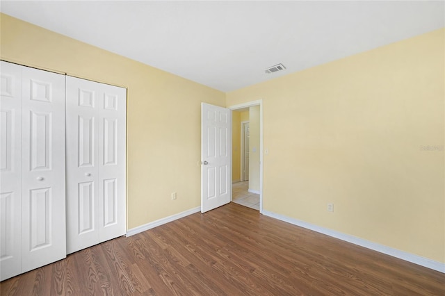4371 Tollefson Ave, North Port, FL 34287 - unfurnished bedroom featuring baseboards, dark wood-style floors, and a closet