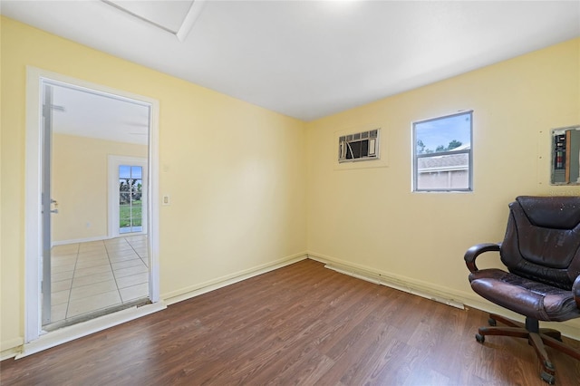 4371 Tollefson Ave, North Port, FL 34287 - unfurnished office featuring wood finished floors, healthy amount of natural light, electric panel, and a wall mounted AC