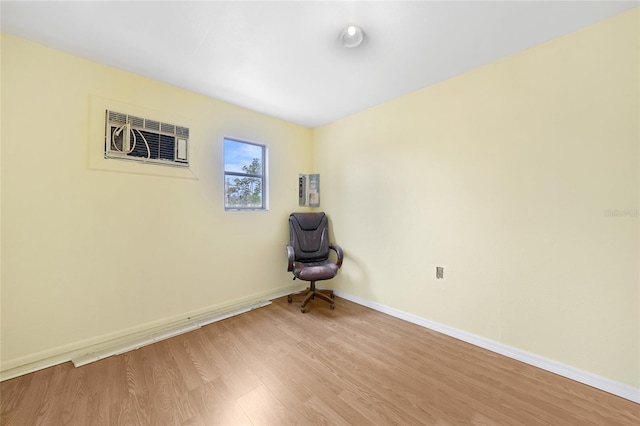 4371 Tollefson Ave, North Port, FL 34287 - unfurnished room featuring a wall unit AC, light wood-type flooring, and baseboards