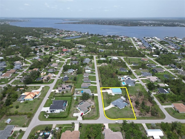 5412 Ulysses St, Port Charlotte, FL 33981 - aerial view of property and surrounding area featuring a nearby body of water, property parcel outlined, and nearby suburban area