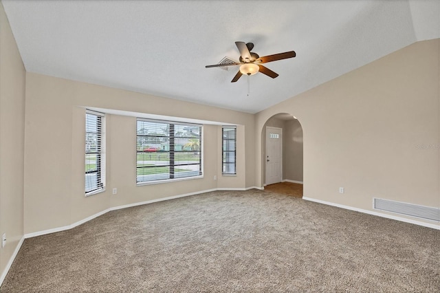 5412 Ulysses St, Port Charlotte, FL 33981 - carpeted empty room with ceiling fan, lofted ceiling, arched walkways, and baseboards