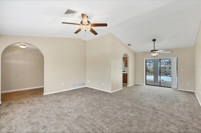 5412 Ulysses St, Port Charlotte, FL 33981 - spare room featuring a ceiling fan, arched walkways, carpet, baseboards, and vaulted ceiling
