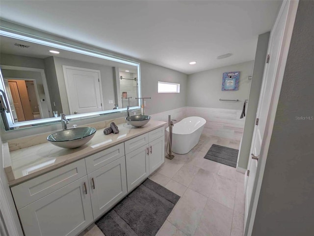 608 Saint Judes Dr, Longboat Key, FL 34228 - bathroom featuring double vanity, a freestanding tub, and a shower stall
