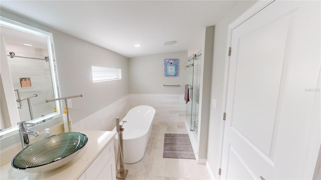 608 Saint Judes Dr, Longboat Key, FL 34228 - full bath with vanity, a freestanding bath, a shower stall, tile patterned flooring, and recessed lighting