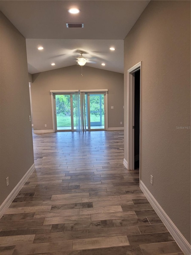 134 Swan Dr, Rotonda West, FL 33947 - hall featuring dark wood-style flooring, lofted ceiling, and recessed lighting