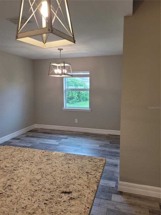 134 Swan Dr, Rotonda West, FL 33947 - empty room featuring a chandelier and wood finished floors