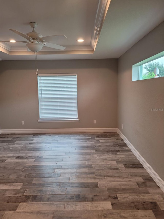 134 Swan Dr, Rotonda West, FL 33947 - unfurnished room with a raised ceiling, ornamental molding, wood finished floors, ceiling fan, and recessed lighting