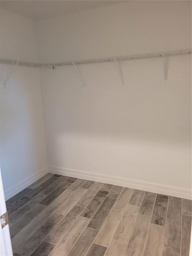 134 Swan Dr, Rotonda West, FL 33947 - walk in closet with dark wood finished floors