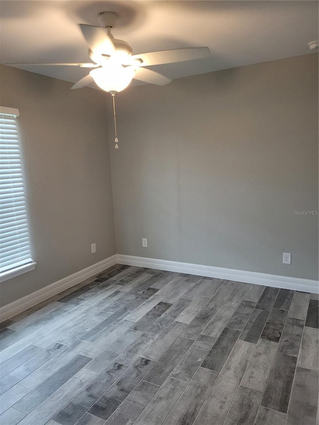 134 Swan Dr, Rotonda West, FL 33947 - empty room featuring ceiling fan, dark wood finished floors, and plenty of natural light