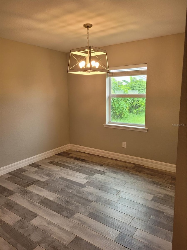 134 Swan Dr, Rotonda West, FL 33947 - unfurnished room featuring a chandelier and wood finished floors