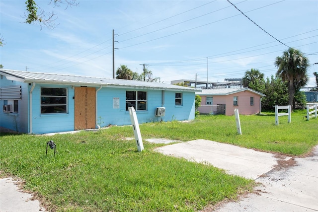 1999 Placida Rd, Englewood, FL 34223 - view of front of home with a front lawn and a metal roof