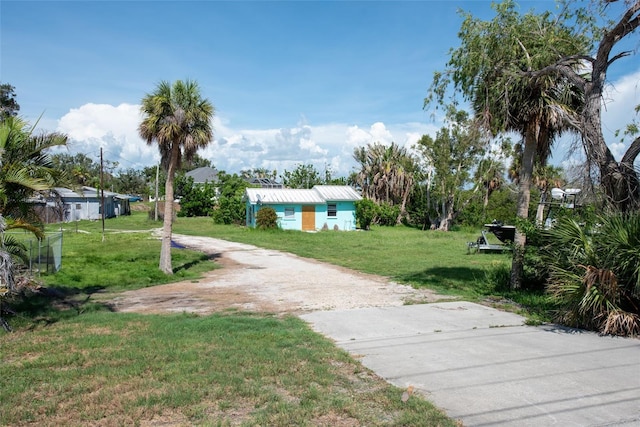 1999 Placida Rd, Englewood, FL 34223 - view of green lawn featuring dirt driveway