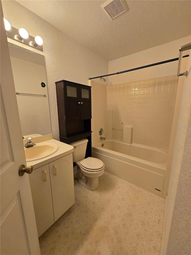 4900 Hurley Ave, North Port, FL 34288 - bathroom with a textured wall, a textured ceiling, vanity, shower / tub combination, and tile patterned floors