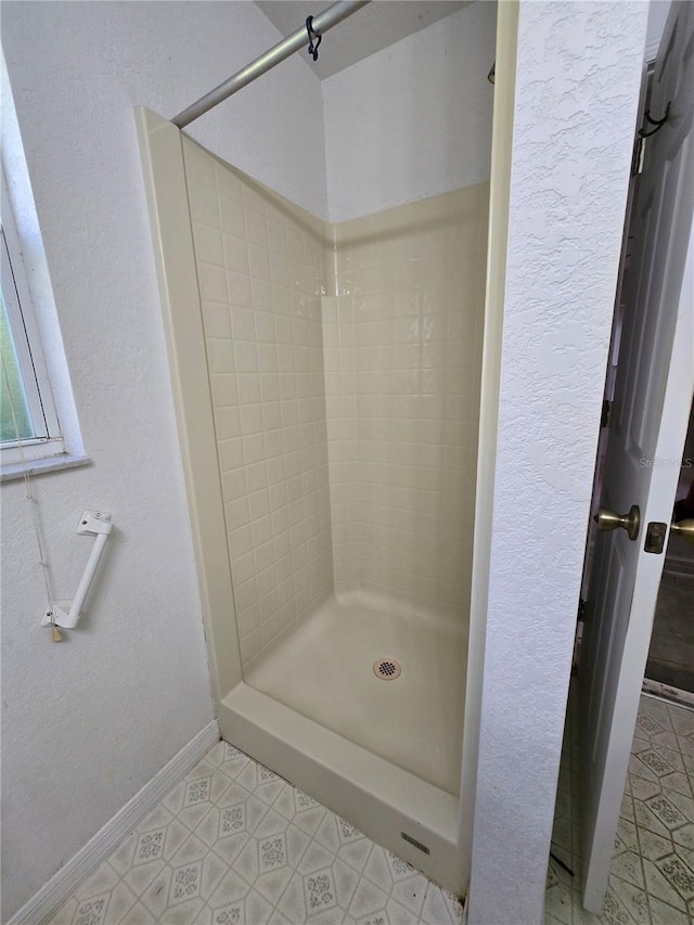 4900 Hurley Ave, North Port, FL 34288 - full bathroom featuring a stall shower, tile patterned flooring, and a textured wall