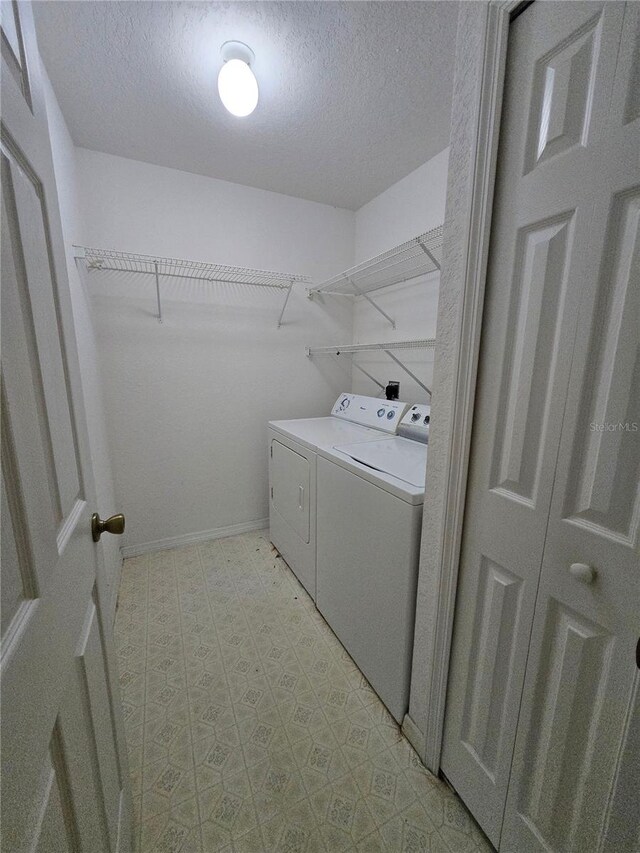 4900 Hurley Ave, North Port, FL 34288 - washroom featuring independent washer and dryer, a textured ceiling, and light flooring