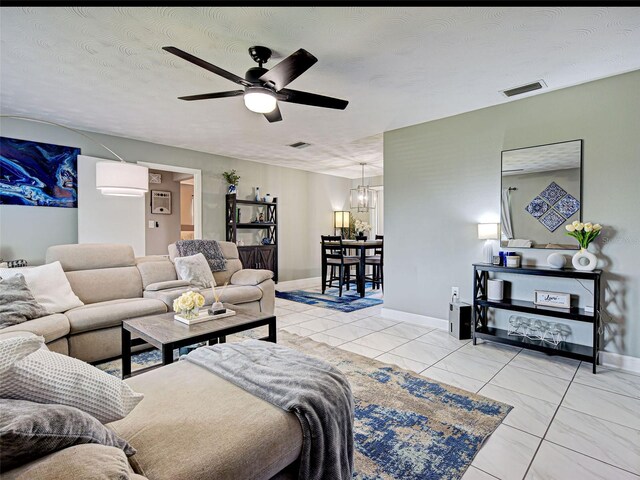 21519 Fairway Ave, Port Charlotte, FL 33952 - living room with a chandelier, ceiling fan, and baseboards