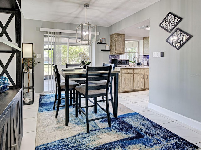 21519 Fairway Ave, Port Charlotte, FL 33952 - dining area featuring a chandelier, baseboards, and light tile patterned floors
