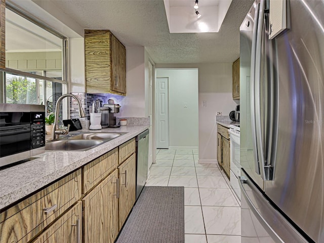 21519 Fairway Ave, Port Charlotte, FL 33952 - kitchen featuring appliances with stainless steel finishes, a sink, light marble finish flooring, light countertops, and a textured ceiling