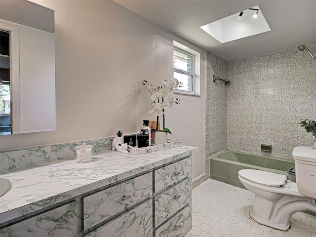 21519 Fairway Ave, Port Charlotte, FL 33952 - full bath with toilet, bathtub / shower combination, vanity, tile patterned flooring, and a skylight