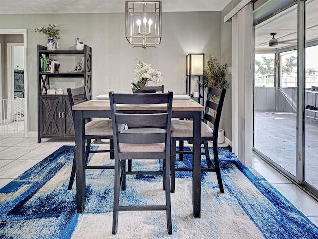21519 Fairway Ave, Port Charlotte, FL 33952 - dining space featuring a chandelier, light tile patterned floors, and baseboards