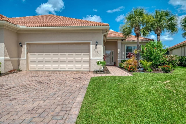 13051 Creekside Ln, Port Charlotte, FL 33953 - mediterranean / spanish-style house with stucco siding, decorative driveway, a front lawn, and a garage