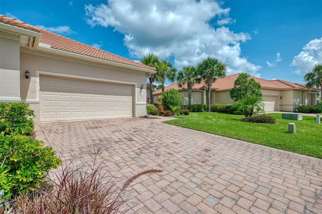 13051 Creekside Ln, Port Charlotte, FL 33953 - view of front of home with decorative driveway, stucco siding, a front lawn, a garage, and a tiled roof