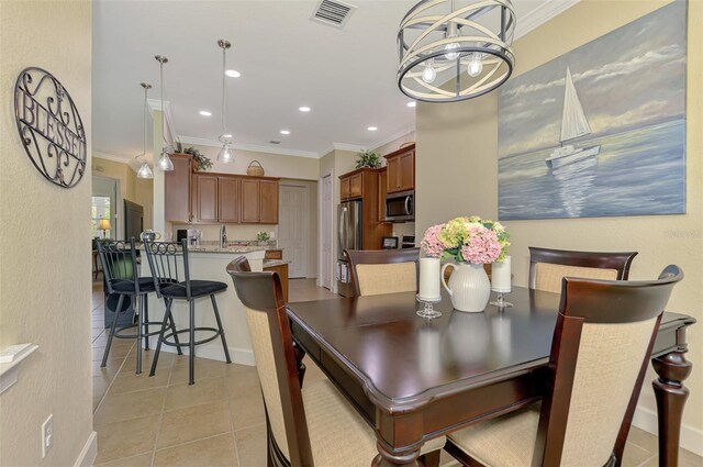 13051 Creekside Ln, Port Charlotte, FL 33953 - dining area featuring crown molding, light tile patterned floors, and recessed lighting