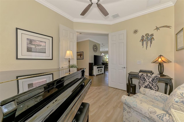 13051 Creekside Ln, Port Charlotte, FL 33953 - sitting room with crown molding, ceiling fan, and light wood-type flooring