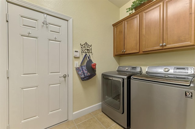 13051 Creekside Ln, Port Charlotte, FL 33953 - laundry room with washer and dryer, cabinet space, and light tile patterned floors