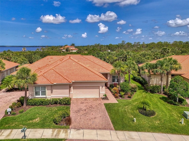 13051 Creekside Ln, Port Charlotte, FL 33953 - view of front of house featuring a garage, stucco siding, a tile roof, a front yard, and decorative driveway