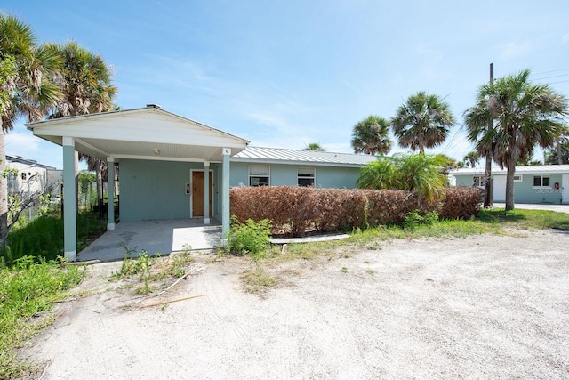 1765 Manor Rd, Englewood, FL 34223 - view of front of property featuring a carport, a metal roof, and stucco siding