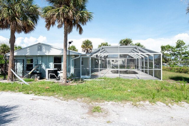 1765 Manor Rd, Englewood, FL 34223 - back of house with an outdoor pool, a patio, and glass enclosure