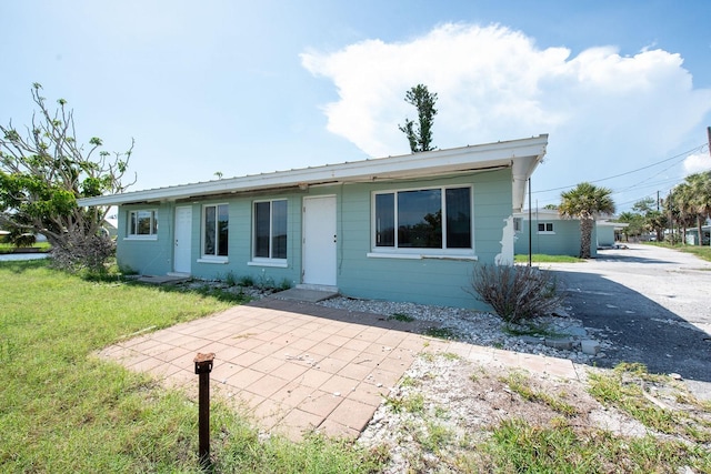 1790 Manor Rd, Englewood, FL 34223 - view of front of home with a front yard and a patio