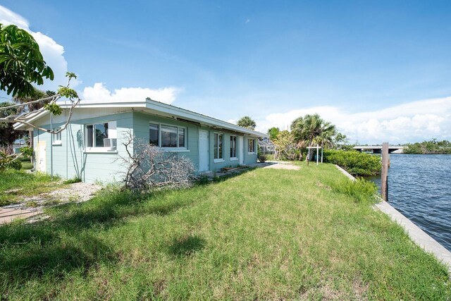 1790 Manor Rd, Englewood, FL 34223 - view of home's exterior with a water view and a yard