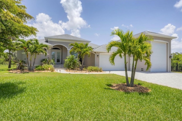 124 Cutlass Dr, Rotonda West, FL 33947 - mediterranean / spanish house featuring french doors, a garage, a front lawn, and stucco siding