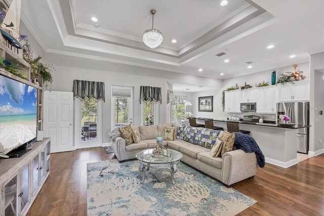 124 Cutlass Dr, Rotonda West, FL 33947 - living room featuring a raised ceiling, dark wood-type flooring, recessed lighting, and crown molding