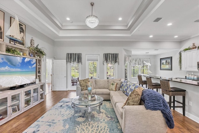 124 Cutlass Dr, Rotonda West, FL 33947 - living area with wood finished floors, a raised ceiling, ornamental molding, and recessed lighting