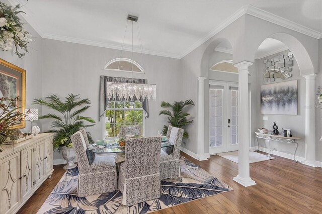 124 Cutlass Dr, Rotonda West, FL 33947 - dining room with ornate columns, wood finished floors, french doors, crown molding, and arched walkways