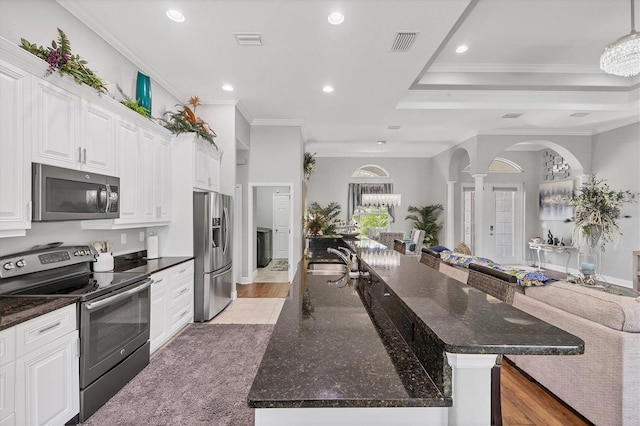 124 Cutlass Dr, Rotonda West, FL 33947 - kitchen with stainless steel appliances, open floor plan, ornate columns, arched walkways, and recessed lighting