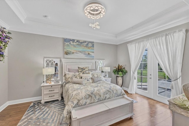 124 Cutlass Dr, Rotonda West, FL 33947 - bedroom with a raised ceiling, ornamental molding, access to exterior, wood finished floors, and a chandelier