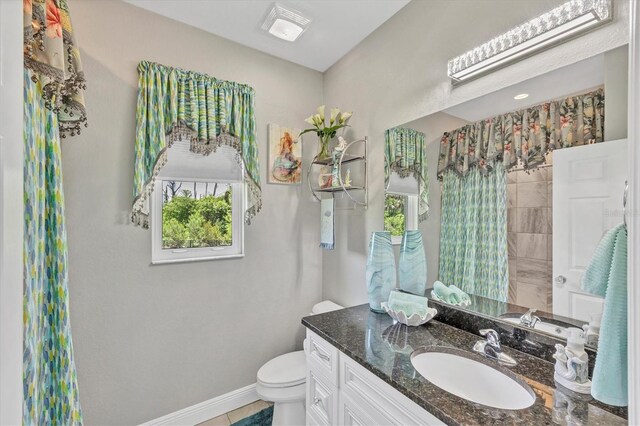 124 Cutlass Dr, Rotonda West, FL 33947 - full bath featuring vanity, plenty of natural light, and a shower with shower curtain