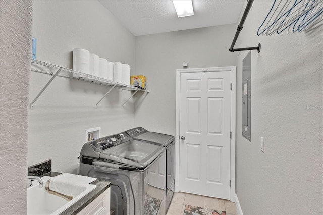 124 Cutlass Dr, Rotonda West, FL 33947 - laundry room featuring washing machine and clothes dryer, a textured wall, a textured ceiling, and light tile patterned floors