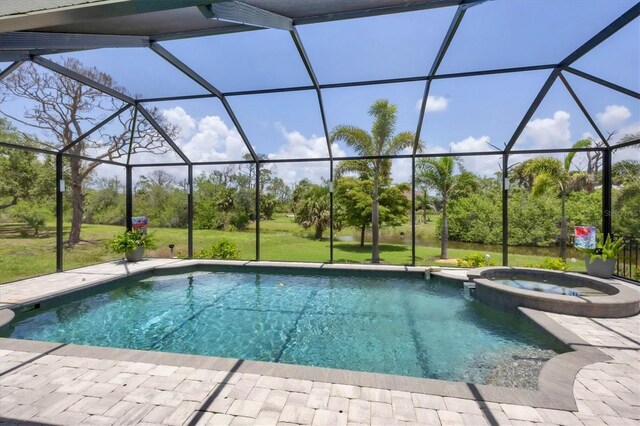 124 Cutlass Dr, Rotonda West, FL 33947 - view of pool featuring a pool with connected hot tub, a lanai, view of wooded area, and a patio area