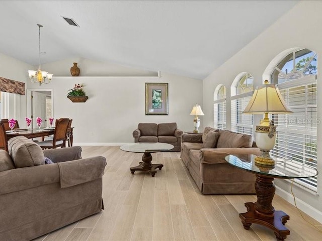 23 Pine Valley Ct, Rotonda West, FL 33947 - living area with a chandelier, healthy amount of natural light, vaulted ceiling, and light wood finished floors