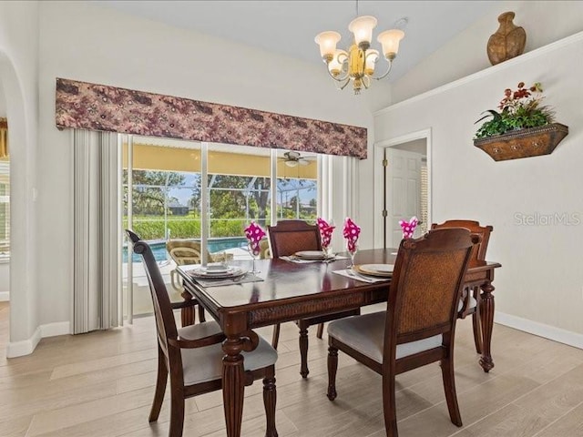 23 Pine Valley Ct, Rotonda West, FL 33947 - dining area featuring arched walkways, a chandelier, light wood-type flooring, and lofted ceiling